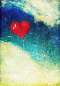 Vintage photo of red heart balloon in the sky